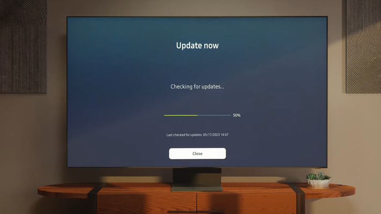 A Samsung TV on a wooden table checking for updates