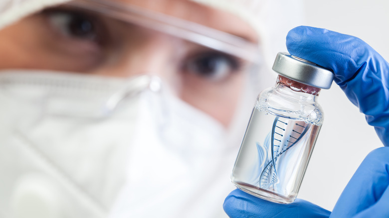 Healthcare professional looks at vaccine vial