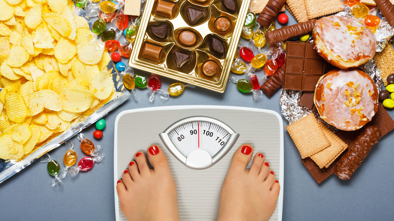 Packaged foods with a person standing on weighing scale