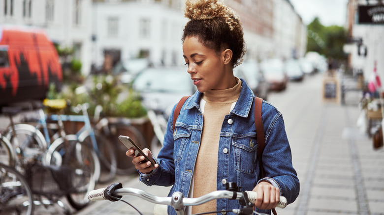 Woman using smartphone to navigate in city