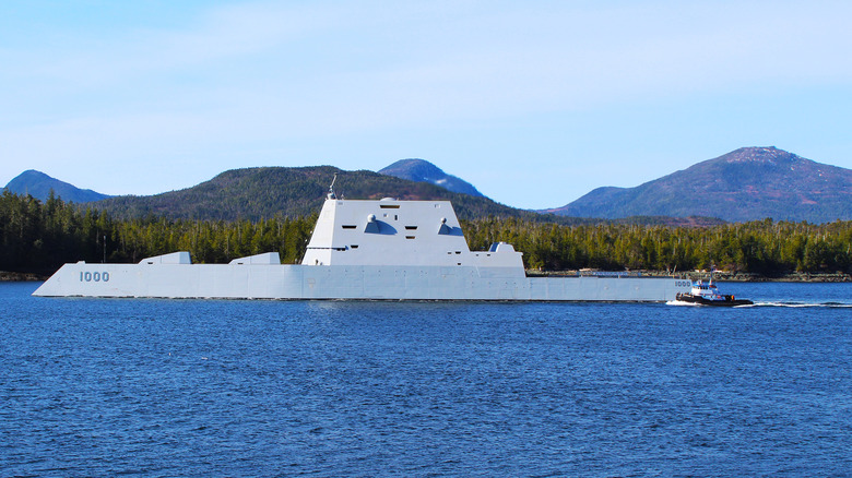 USS Zumwalt at sea with mountains in background