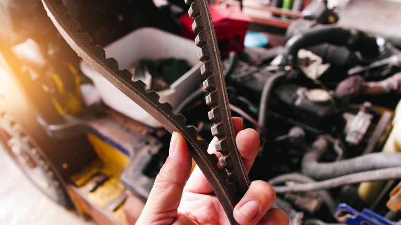 person holding timing belt