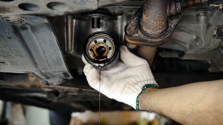 Mechanic removing old oil filter