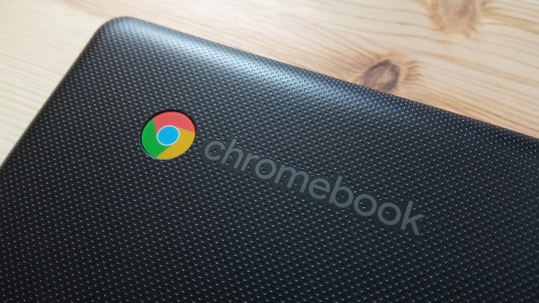 close up of chromebook laptop logo on wooden desk