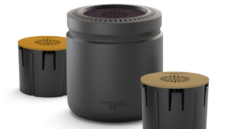 A MoodoGo smart diffuser with two capsules.