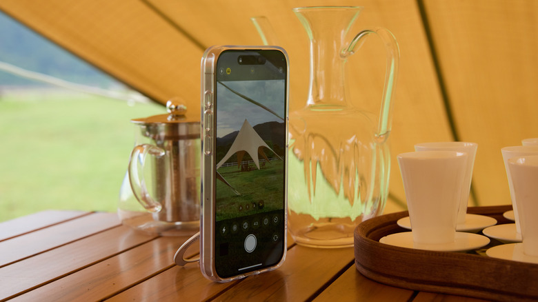 TORRAS Ostand Spin case propped up on a table alongside a tea set