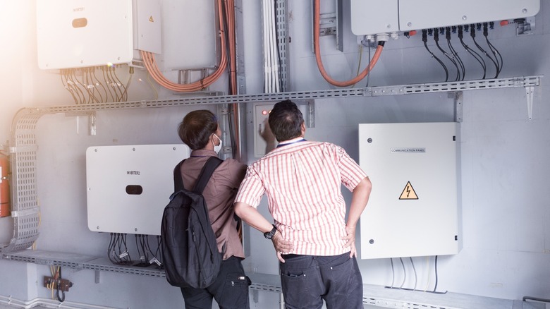 Engineers checking solar inverter