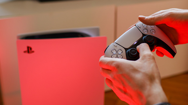 Person holding DualSense controller