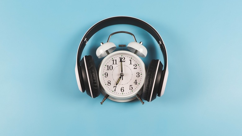 Headphones over top of alarm clock