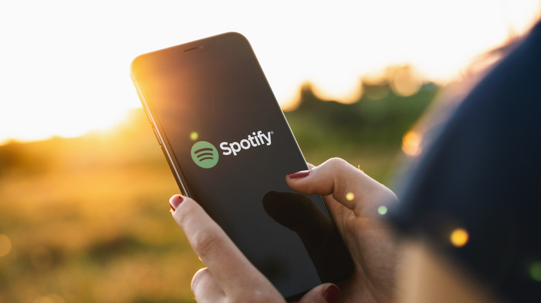 Woman using Spotify on her phone.