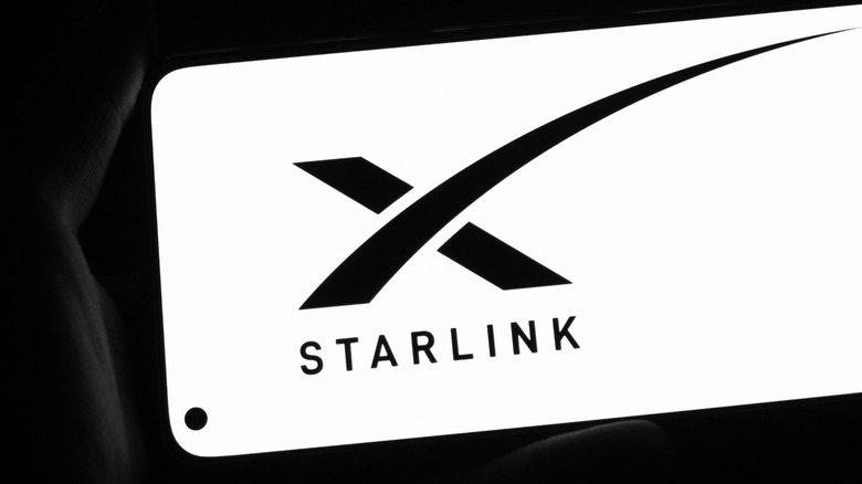 The Starlink logo on a phone screen.