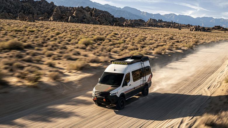 Van driving with a Starlink mounted to the roof