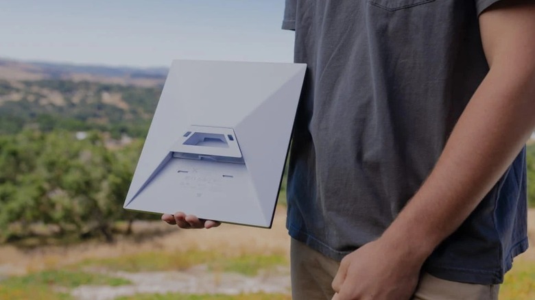 Man carrying Starlink Mini dish