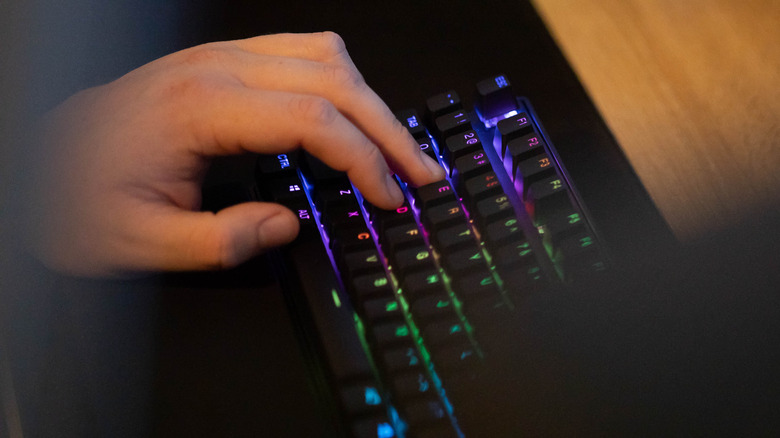 Person gaming on keyboard