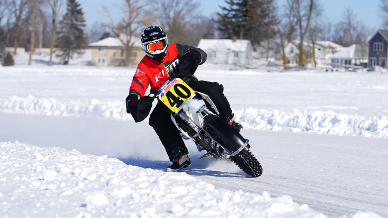 A man riding a motorcycle on a frozen lake