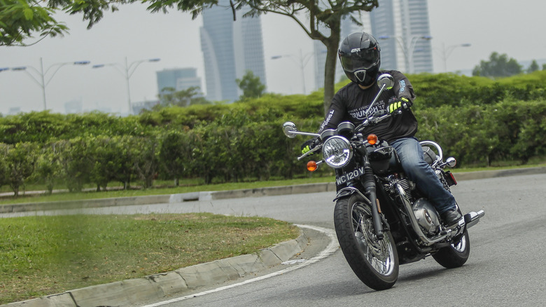 Motorcyclist rides a Triumph Bonneville in Malaysia