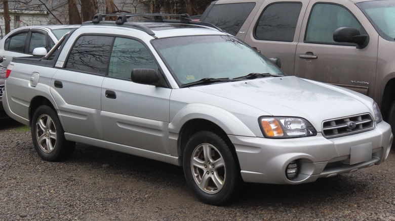 Silver Subaru Baja parked on gravel