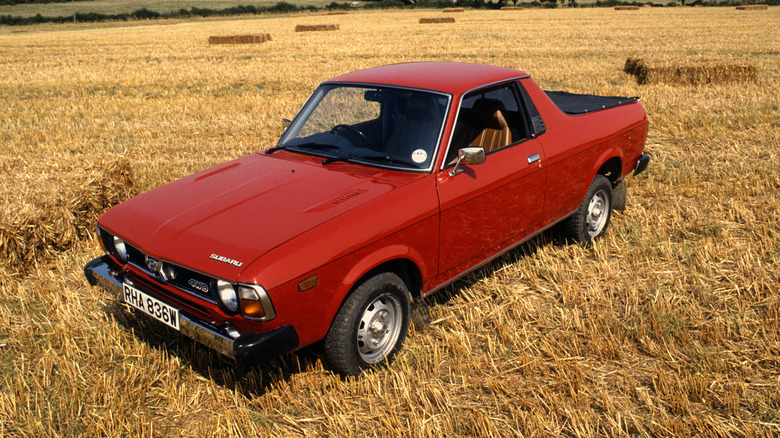 Red Subaru BRAT parked in farm field