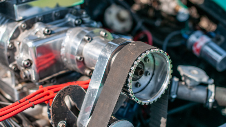 Close up of a supercharger belt idler pulley in the engine bay