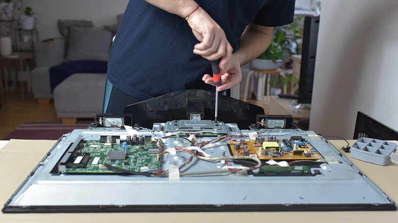 A person trying to fix a smart TV