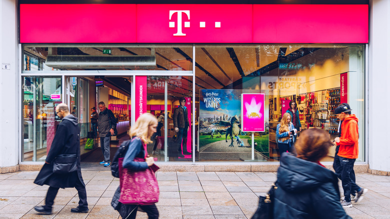 People walking in front of a T-Mobile Store