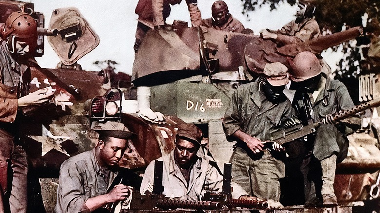 World War II soldiers inspecting equipment