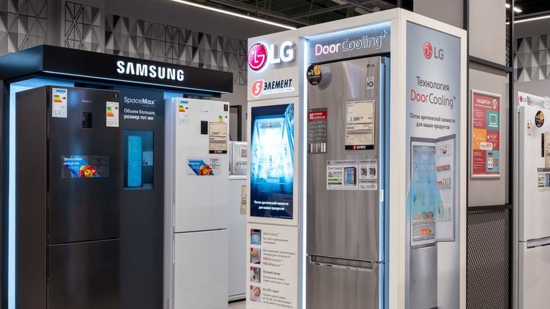 A display of Samsung and LG refrigerators.