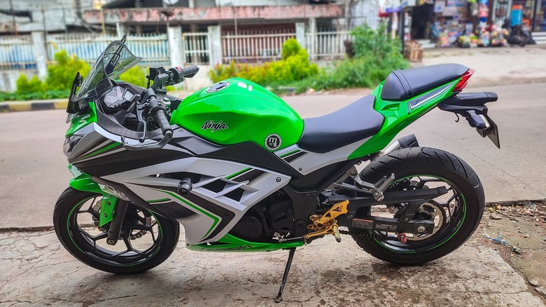 Kawasaki motorcycle parked on sidewalk