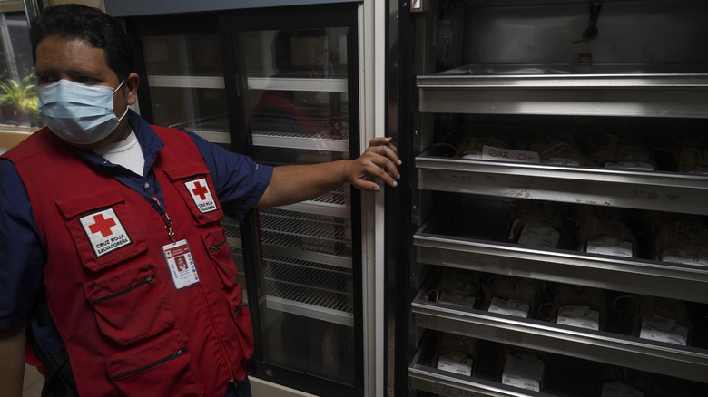 Red Cross worker overseeing stored blood