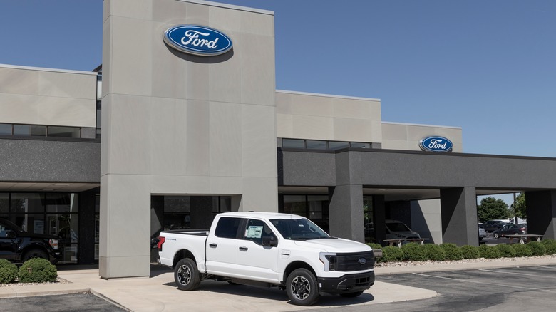 Ford F-150 Lightning in front of dealership 