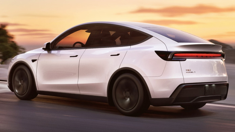 Rear quarter view of the new Tesla Model Y electric car driving on road