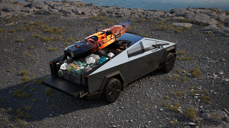 Tesla Cybertruck parked with cargo kayak