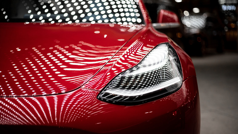 front-facing close-up of red tesla 