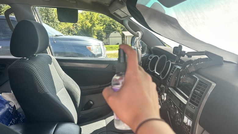 spraying lavendar mist inside car 