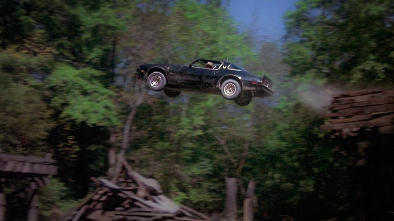 A black 1977 Trans Am jumping over the Jonesboro River in a still image from Smokey and the Bandit