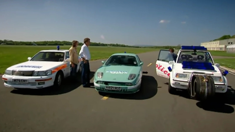 Presenters looking at police cars