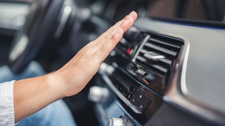 Hand held over car vent