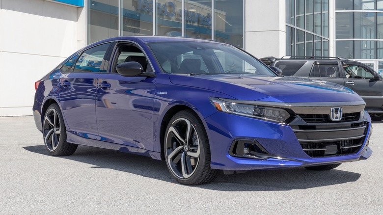 Blue Honda Accord hybrid parked outside a dealership