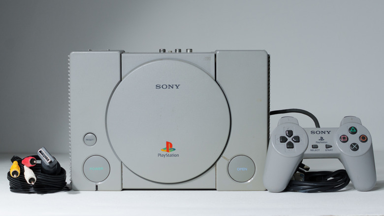 Original PlayStation with its cables and controller