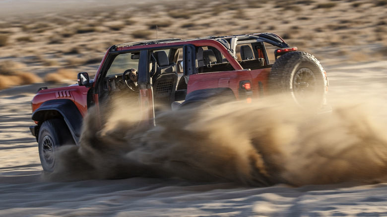 Ford Bronco Raptor racing through sand