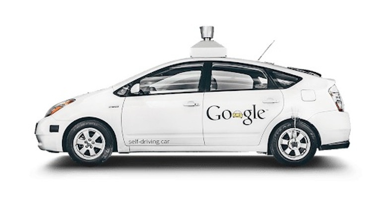 A white Waymo Self-Driving Car with a Google logo on the rear driver's side door