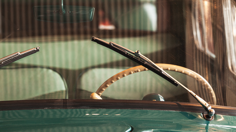 Car windshield wipers cleaning water from the glass