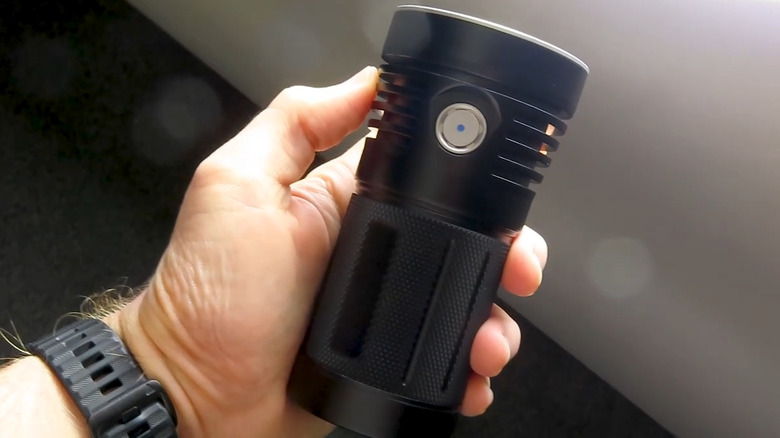 Thrunite flashlight in hand