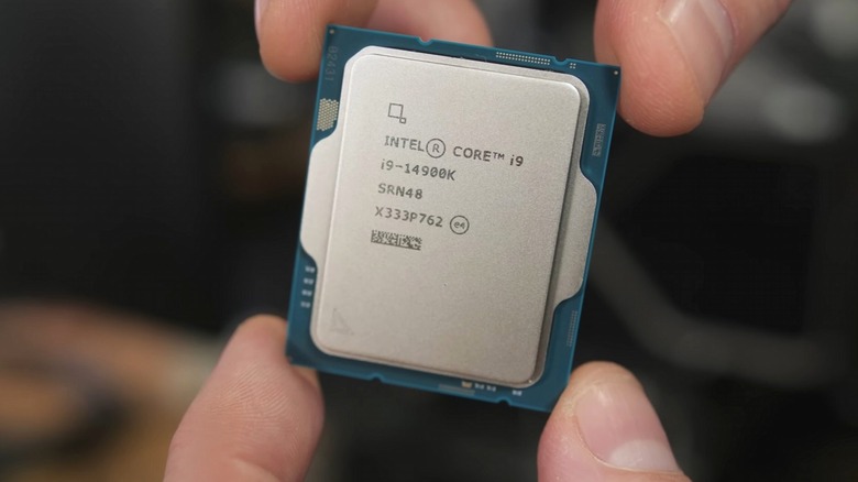 Fingers holding Intel Core i9-14900K CPU