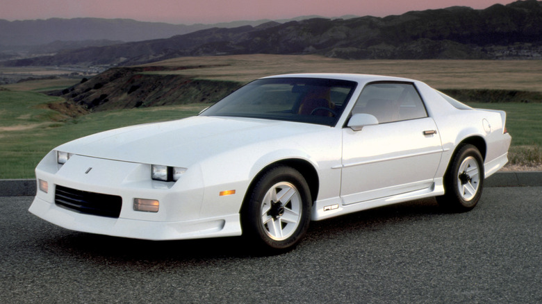 white 1992 Chevy Camaro on road