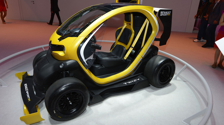 The Renault Twizy F1 at an auto show floor, front 3/4 view