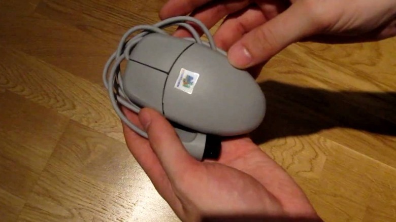 A Nintendo 64 mouse sitting on a desk