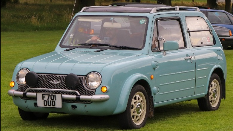 Nissan Pao parked in the grass