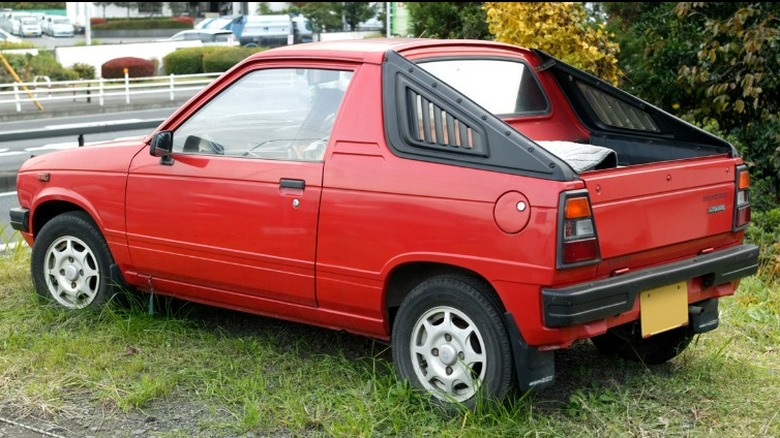 Rear side view of red Suzuki Mighty Boy 