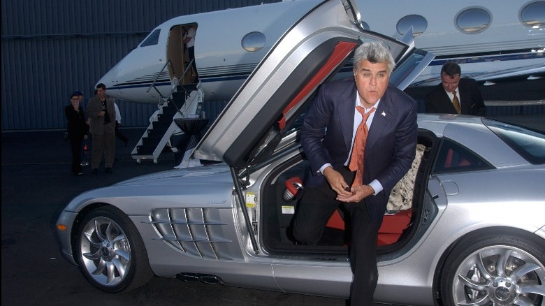 Jay Leno exiting exotic car